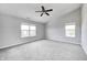 The bedroom has gray walls, a ceiling fan, carpet flooring, and lots of natural light at 3147 Winings Ln, Carmel, IN 46074
