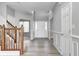 Bright foyer with light gray walls, hardwood floors, a white front door, and staircase with wooden railing at 3147 Winings Ln, Carmel, IN 46074