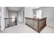 Hallway features wood railing, overhead lighting, and neutral-colored carpet flooring at 3147 Winings Ln, Carmel, IN 46074