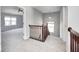 Second floor hallway with carpet and wooden banister at 3147 Winings Ln, Carmel, IN 46074