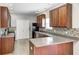 Beautiful kitchen with granite countertops, modern appliances, dark cabinets, and mosaic tile backsplash at 3147 Winings Ln, Carmel, IN 46074