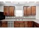 Bright kitchen showcasing stainless steel appliances, a double sink, and ample cabinet space at 3147 Winings Ln, Carmel, IN 46074