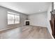 Bright living room with hardwood floors, a fireplace, large windows, and a view of the deck at 3147 Winings Ln, Carmel, IN 46074