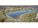 A scenic view of the neighborhood pond on a sunny day, surrounded by landscaped walking paths at 3147 Winings Ln, Carmel, IN 46074