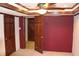 Spacious bedroom featuring a ceiling fan, wood trim, and paneled doors at 3208 Brookside Pkwy N Dr, Indianapolis, IN 46218