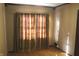 Bedroom featuring hardwood floors, neutral walls, window with curtains, and wood trim at 3208 Brookside Pkwy N Dr, Indianapolis, IN 46218