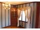 Charming dining room with decorative chandelier, corner cabinet, and unique striped wallpaper at 3208 Brookside Pkwy N Dr, Indianapolis, IN 46218