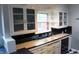 Traditional-style kitchen featuring white cabinets, tile countertops, black backsplash, and a double sink at 3208 Brookside Pkwy N Dr, Indianapolis, IN 46218