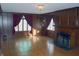 Spacious room with hardwood floors, fireplace, and traditional chandelier at 3208 Brookside Pkwy N Dr, Indianapolis, IN 46218