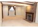 Spacious living room featuring a brick fireplace, plush carpeting, and large window at 3208 Brookside Pkwy N Dr, Indianapolis, IN 46218