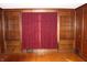 Cozy room with hardwood floors and bespoke built-in wooden bookshelves at 3208 Brookside Pkwy N Dr, Indianapolis, IN 46218