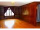 Elegant room with hardwood floors, wood paneling, and natural light at 3208 Brookside Pkwy N Dr, Indianapolis, IN 46218