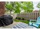 Cozy backyard patio with a grill, outdoor seating, privacy fence, and green landscaping, perfect for outdoor entertaining at 354 E Arch St, Indianapolis, IN 46202