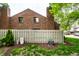 Spacious backyard with lush green grass, white fence, mature trees, and well-maintained landscaping creating a private oasis at 354 E Arch St, Indianapolis, IN 46202
