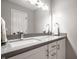 Bathroom with double sinks, chrome faucets, and white cabinets at 354 E Arch St, Indianapolis, IN 46202