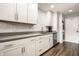 Updated kitchen features white cabinets, stainless appliances, modern countertops and stacked laundry at 354 E Arch St, Indianapolis, IN 46202