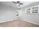 An empty bedroom with neutral walls, a ceiling fan and carpeted floor offers a blank canvas for personalization at 3541 N Linwood Ave, Indianapolis, IN 46218