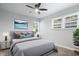 A stylish bedroom featuring a comfortable bed with neutral colors, a modern ceiling fan and plenty of natural light at 3541 N Linwood Ave, Indianapolis, IN 46218