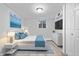 A bright bedroom is staged with modern furniture, stylish decor, and new flooring, creating a tranquil space at 3541 N Linwood Ave, Indianapolis, IN 46218