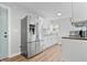 Modern kitchen featuring stainless steel appliances and white cabinetry and hardwood floors at 3541 N Linwood Ave, Indianapolis, IN 46218