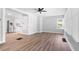 Open living space with wood flooring and modern ceiling fan with easy kitchen access at 3541 N Linwood Ave, Indianapolis, IN 46218