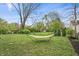 Large backyard with a hammock, mature trees, and a privacy fence at 3818 Kessler Boulevard East Dr, Indianapolis, IN 46220