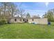 A backyard view featuring a hammock, kayaks, and lush greenery at 3818 Kessler Boulevard East Dr, Indianapolis, IN 46220