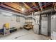 Unfinished basement featuring exposed utilities, a furnace, and ample storage space at 3818 Kessler Boulevard East Dr, Indianapolis, IN 46220