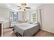 Bedroom with a ceiling fan, neutral decor, and natural light from two windows at 3818 Kessler Boulevard East Dr, Indianapolis, IN 46220