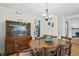 Bright dining room features hardwood floors, traditional wooden table with seating for six, and classic china cabinet at 3818 Kessler Boulevard East Dr, Indianapolis, IN 46220