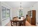 Bright dining room with hardwood floors, natural light and traditional wooden table with seating for six at 3818 Kessler Boulevard East Dr, Indianapolis, IN 46220