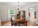 Bright dining room features hardwood floors, natural light and traditional wooden table with seating for six at 3818 Kessler Boulevard East Dr, Indianapolis, IN 46220