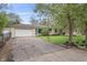 Charming home with attached garage, lush lawn, and stone exterior details at 3818 Kessler Boulevard East Dr, Indianapolis, IN 46220