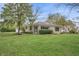 Charming home exterior with stone detail, screened-in porch, and a well-kept lawn at 3818 Kessler Boulevard East Dr, Indianapolis, IN 46220