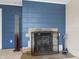 Basement fireplace with a decorative screen and classic fireplace tools at 3818 Kessler Boulevard East Dr, Indianapolis, IN 46220