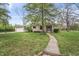 Inviting single-story home with stone facade, manicured lawn, and concrete walkway at 3818 Kessler Boulevard East Dr, Indianapolis, IN 46220