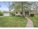 Inviting home with stone facade, manicured lawn, and a walkway to the entrance at 3818 Kessler Boulevard East Dr, Indianapolis, IN 46220