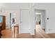 Bright hallway with hardwood floors and crisp white trim throughout the home at 3818 Kessler Boulevard East Dr, Indianapolis, IN 46220