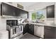 Efficient kitchen boasts black cabinets, stainless steel appliances and bright natural light at 3818 Kessler Boulevard East Dr, Indianapolis, IN 46220