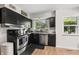 Efficient kitchen boasts black cabinets, stainless steel appliances and bright natural light at 3818 Kessler Boulevard East Dr, Indianapolis, IN 46220