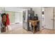 Bright kitchen area featuring stainless steel appliances, a rolling island, and an open doorway to a powder room at 3818 Kessler Boulevard East Dr, Indianapolis, IN 46220