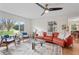 This comfortable living room features a view of the street, an orange couch and wood floors at 3818 Kessler Boulevard East Dr, Indianapolis, IN 46220