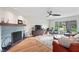 Bright living room features a stylish ceiling fan and cozy seating area with a view at 3818 Kessler Boulevard East Dr, Indianapolis, IN 46220