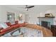 Inviting living room showcases hardwood floors, a fireplace and a comfortable red sofa at 3818 Kessler Boulevard East Dr, Indianapolis, IN 46220
