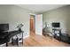 Home office with neutral walls, wood floors, and two work spaces at 3818 Kessler Boulevard East Dr, Indianapolis, IN 46220