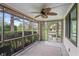 Enjoy relaxing on this screened porch with a lovely view of trees and foliage around the property at 3818 Kessler Boulevard East Dr, Indianapolis, IN 46220