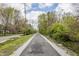 A straight and smooth walking trail with greenery on either side at 3818 Kessler Boulevard East Dr, Indianapolis, IN 46220