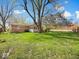 Backyard featuring a sprawling lawn, shade trees, and part of the home with an adjacent deck at 390 Lakeview Dr, Noblesville, IN 46060