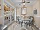 Cozy dining area with glass top table, ceiling fan, and french doors providing natural light and backyard view at 390 Lakeview Dr, Noblesville, IN 46060