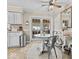 Charming dining area featuring glass top table, white cabinets and French doors offering a seamless indoor-outdoor experience at 390 Lakeview Dr, Noblesville, IN 46060